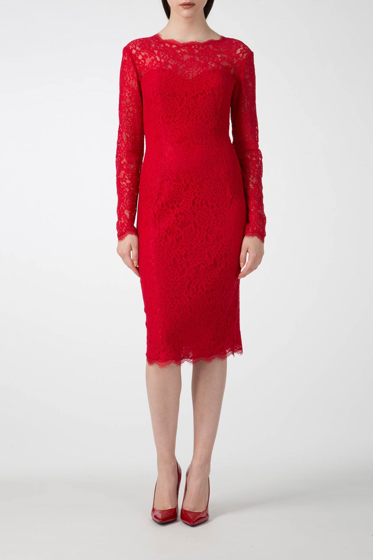 A person is elegantly wearing the Antonio Croce Ambeta Long-Sleeve Lace Dress, which features a vintage red lace design and falls to knee length. Paired with matching red high-heeled shoes, this Antonio Croce piece stands out against the plain white background, creating an elegant look.