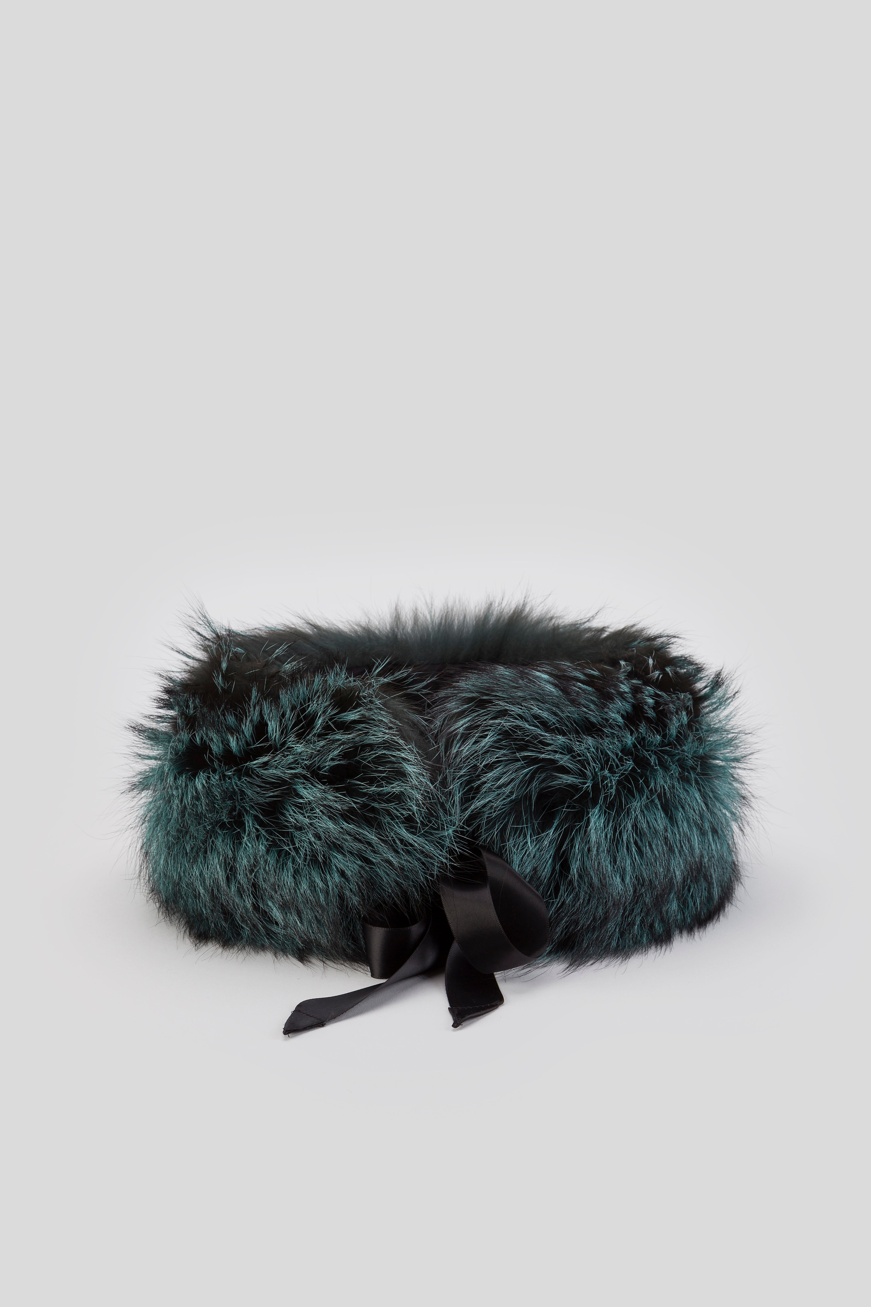The Antonio Croce Fairy Fur Collar is a chic circular accessory featuring fluffy black and teal fur with a sleek black ribbon tied at the front, ideal for enhancing your winter wardrobe. Set against a light gray background, this stylish piece epitomizes the elegance of Antonio Croce.