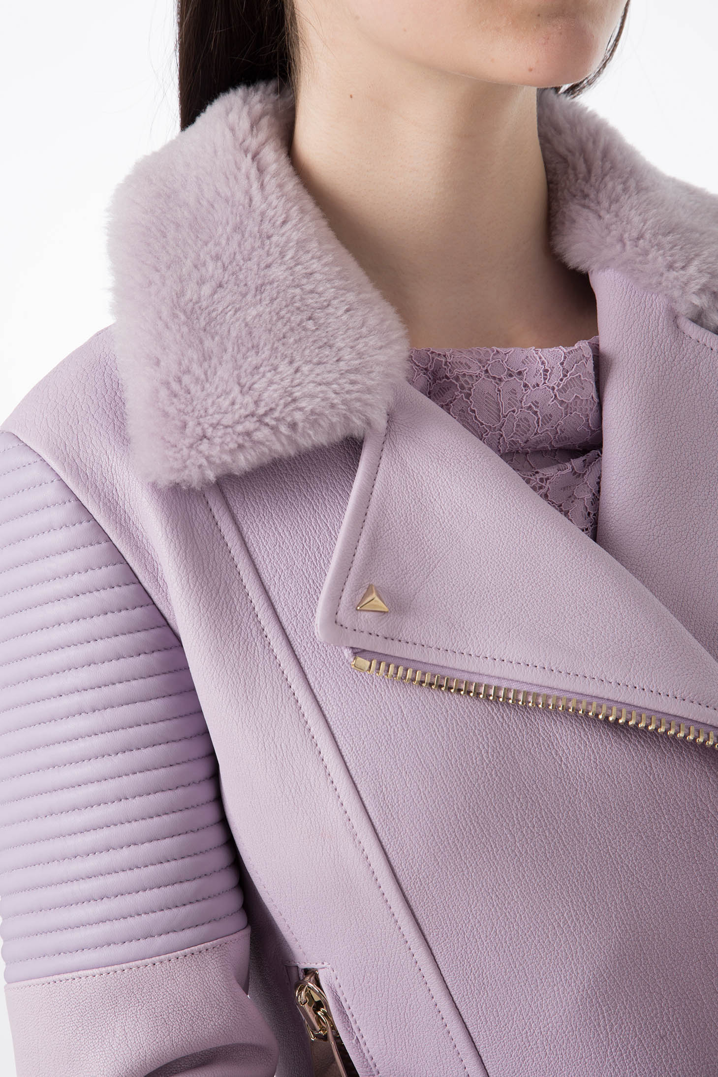 Close-up of a person wearing the Antonio Croce Green Leather Jacket, featuring an asymmetric zipper closure and a luxurious fur collar, paired with a lace top underneath. The focus is on the fabric and design details.