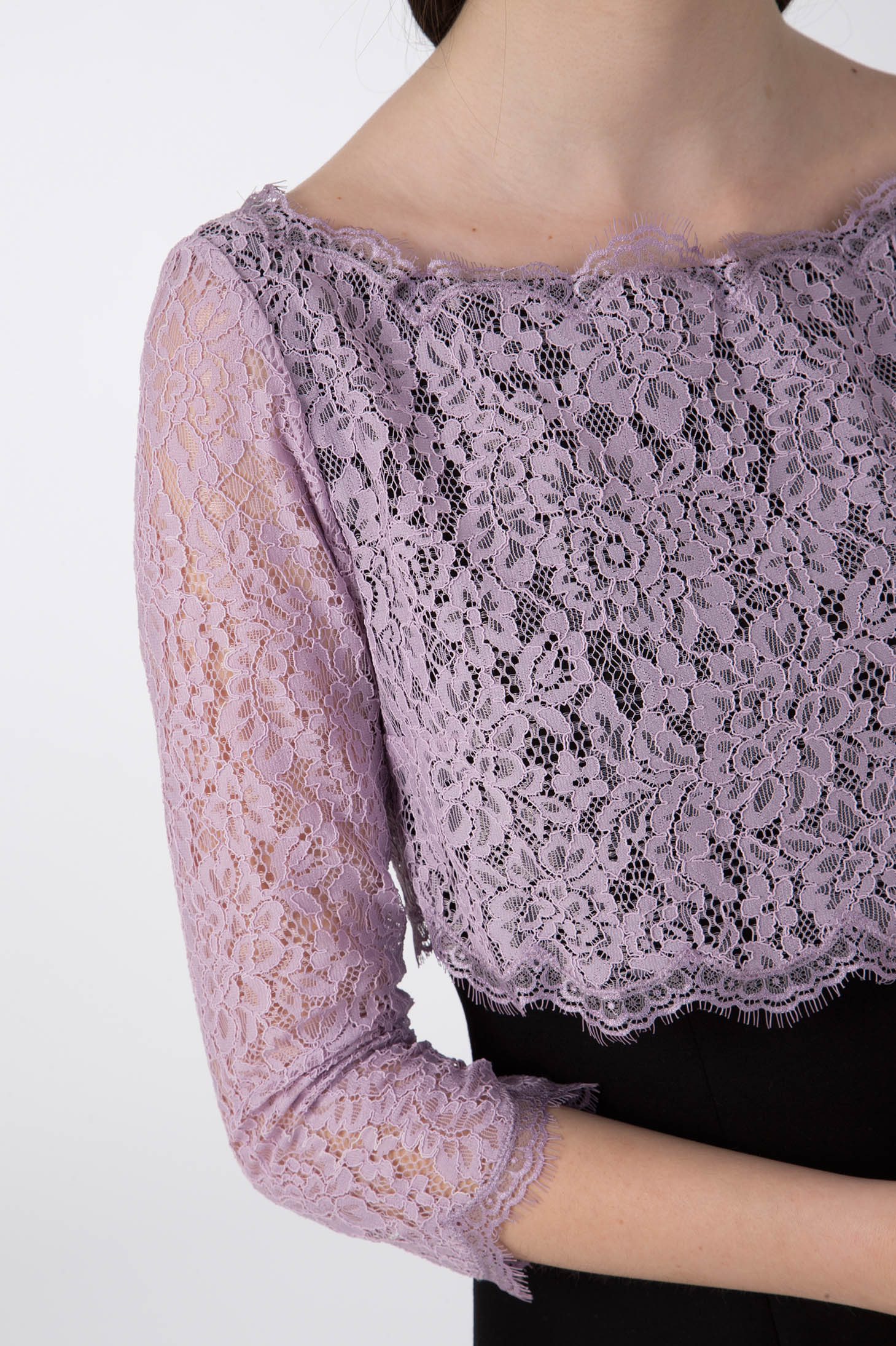 A person wearing the stylish Antonio Croce Artemide Two-Tone Dress, which features a lilac lace bodice top with three-quarter sleeves and an elegant black A-line silhouette, set against a plain white background.