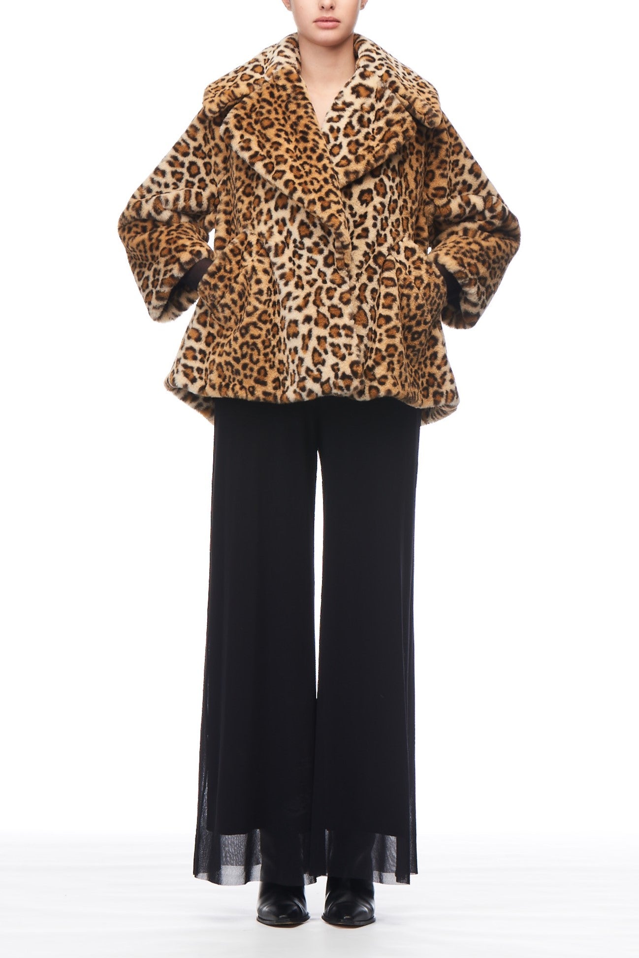 A person wearing a Fuzzi Woman Leopard Print Jacket and black wide-leg pants stands elegantly against a white background.