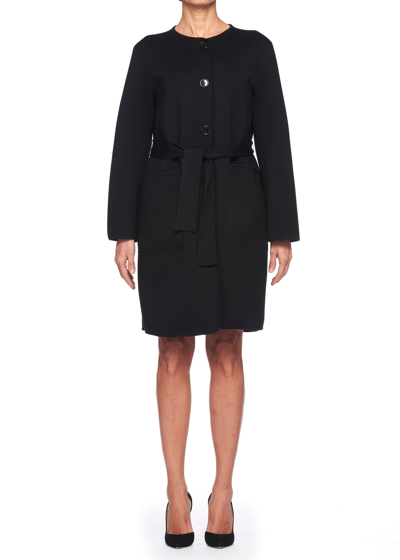 A person wearing the Fuzzi Woman Belted Wool Coat, a vintage-inspired black knee-length piece from Fuzzi featuring a tied belt and buttons, stands against a white background. Paired with black heels, they embody timeless elegance in winter fashion.