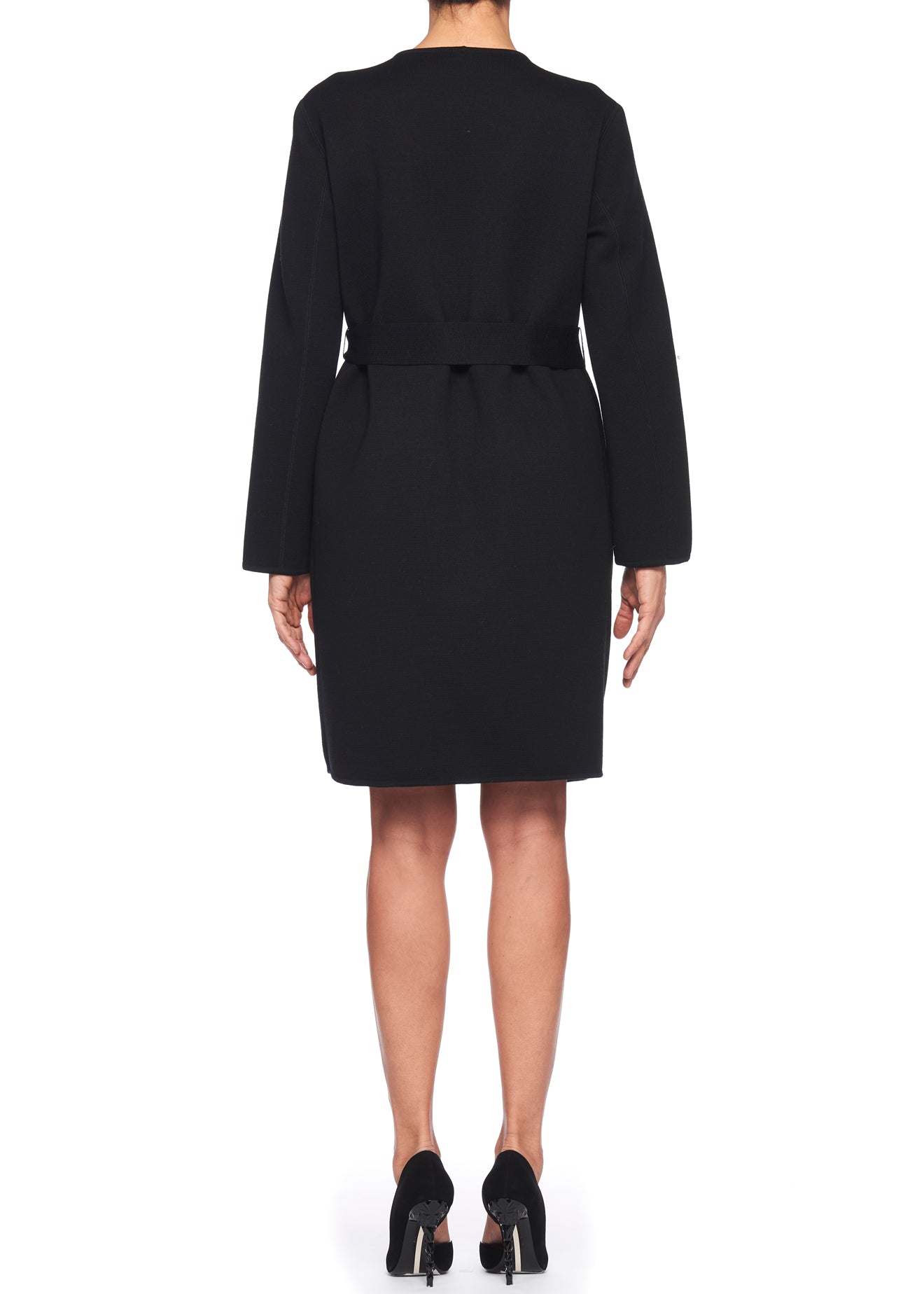 Rear view of a person wearing the Fuzzi Woman Belted Wool Coat, featuring a black knee-length puffer design, standing against a white background. They have short black high-heeled shoes, epitomizing winter fashion elegance.