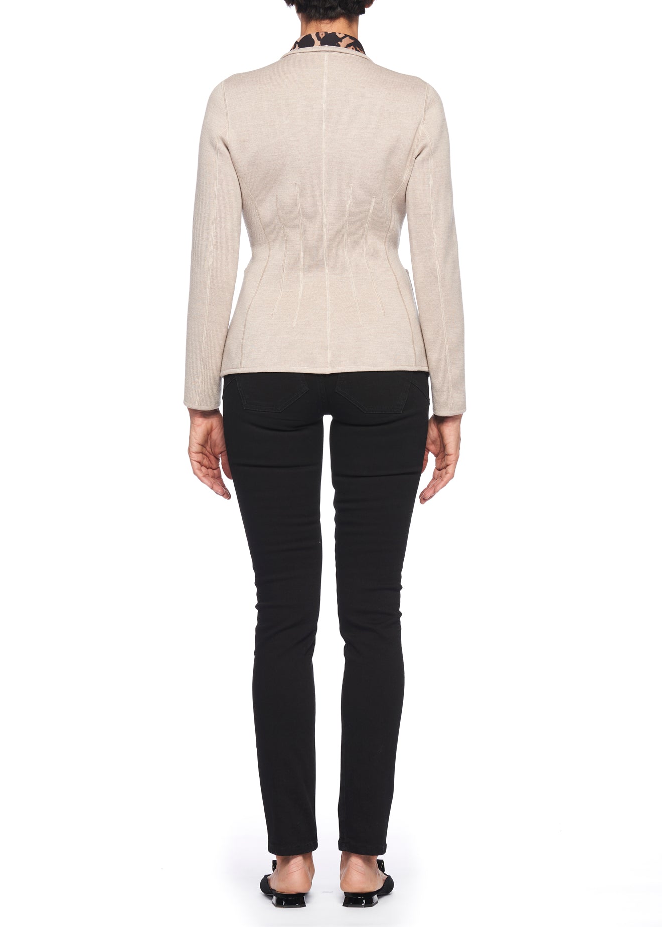 Rear view of a person wearing a beige Fuzzi Woman Jacquard Jacket, black pants, and black shoes. The individual with short, dark curly hair stands against a white background, evoking the classic style of fall and winter fashion.