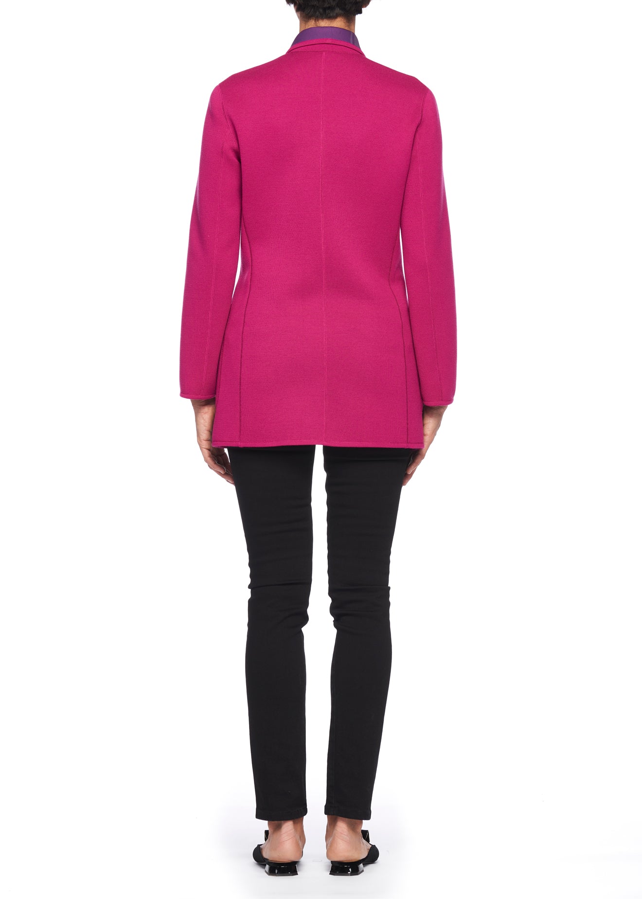 A person is wearing the Fuzzi Woman Reversible Wool Blazer in a vibrant pink, evoking a vintage style, paired with black pants as seen from behind. Their shoes are black, all set against a plain white background.