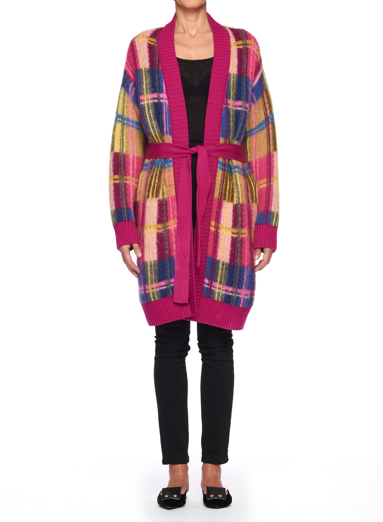 A person wearing the Fuzzi Woman Cardigan Coat over a black top and pants stands against a plain white background. This oversized piece, from the brand Fuzzi, features a long design with colorful plaid patches in pink, blue, and yellow hues and is cinched at the waist with a belt.