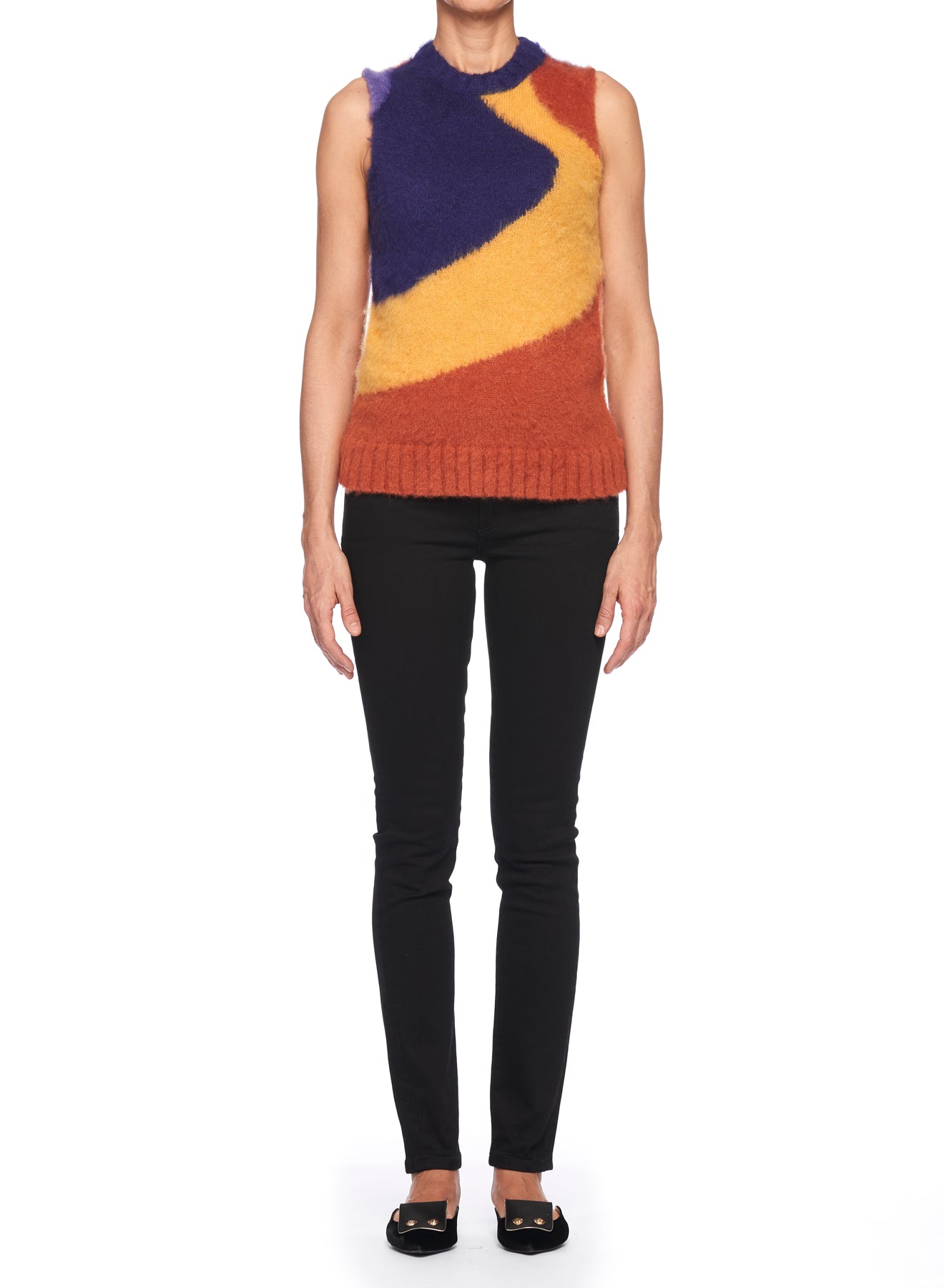 A person stands against a white background, wearing the Fuzzi Woman Abstract Art Vest in a vibrant color-blocked pattern of purple, orange, and yellow. The abstract design pairs perfectly with black pants and shoes, creating an eye-catching look.