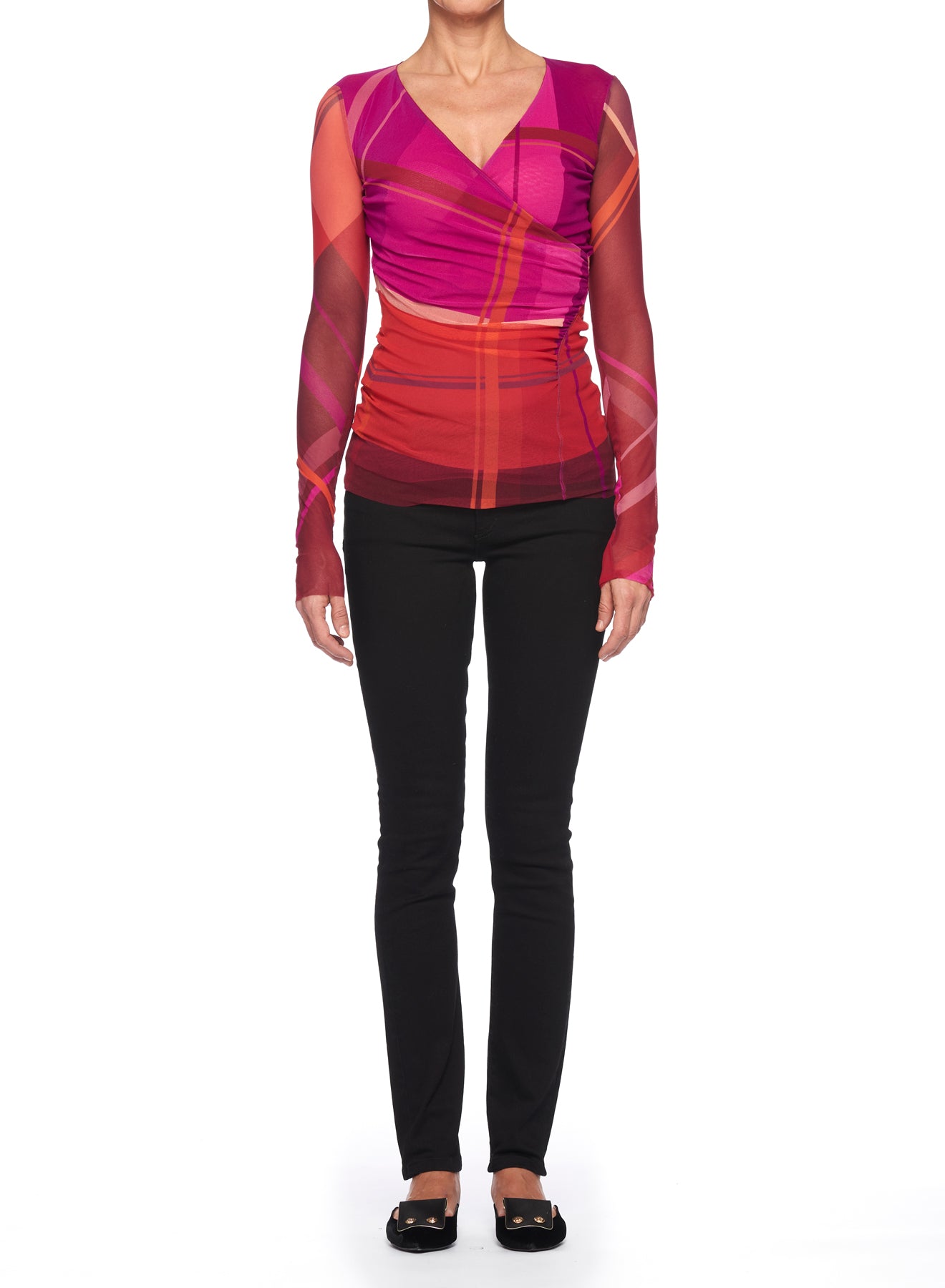 A person wearing a Fuzzi Woman Mesh Top with V-Neck in vibrant shades of pink and red pairs it with black pants and black flat shoes, standing against a plain white background.