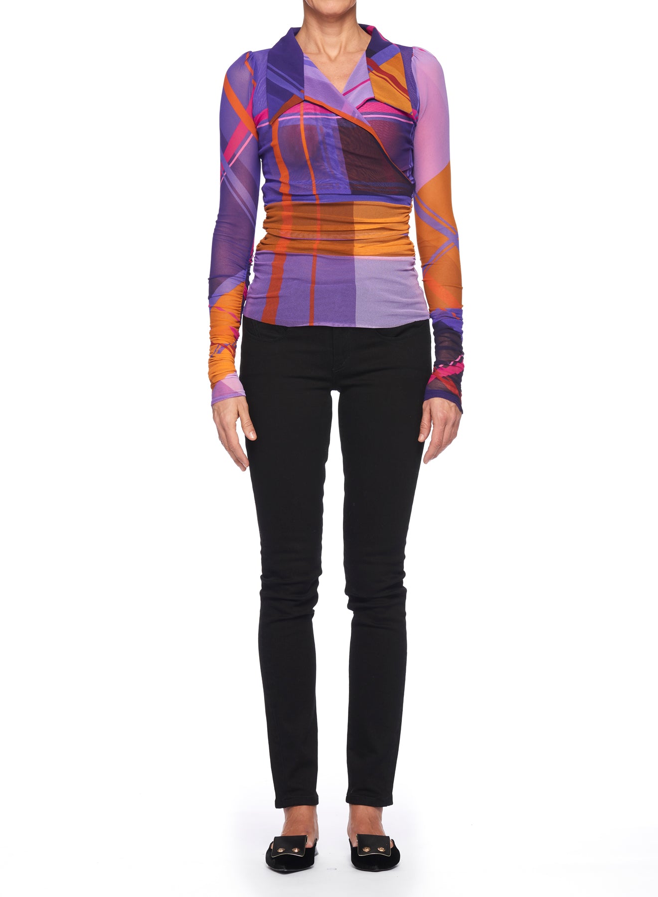 A person wearing the Fuzzi Woman Mesh Top with Geometric Pattern, featuring vibrant long sleeves in purple, orange, and pink hues, is paired with black pants and shoes while standing against a white background.