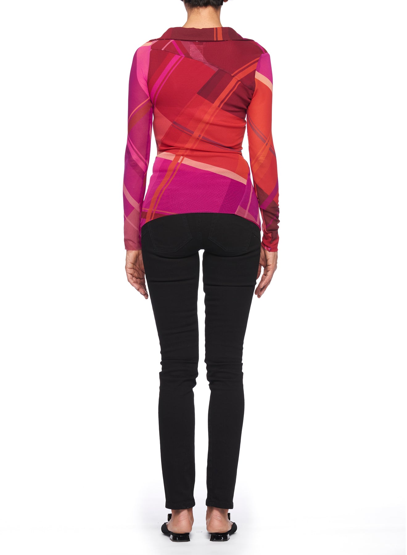 Person facing away, wearing the Fuzzi Woman Colorful Mesh Blouse featuring red and pink abstract prints, paired with black pants. They stand on a plain white background.