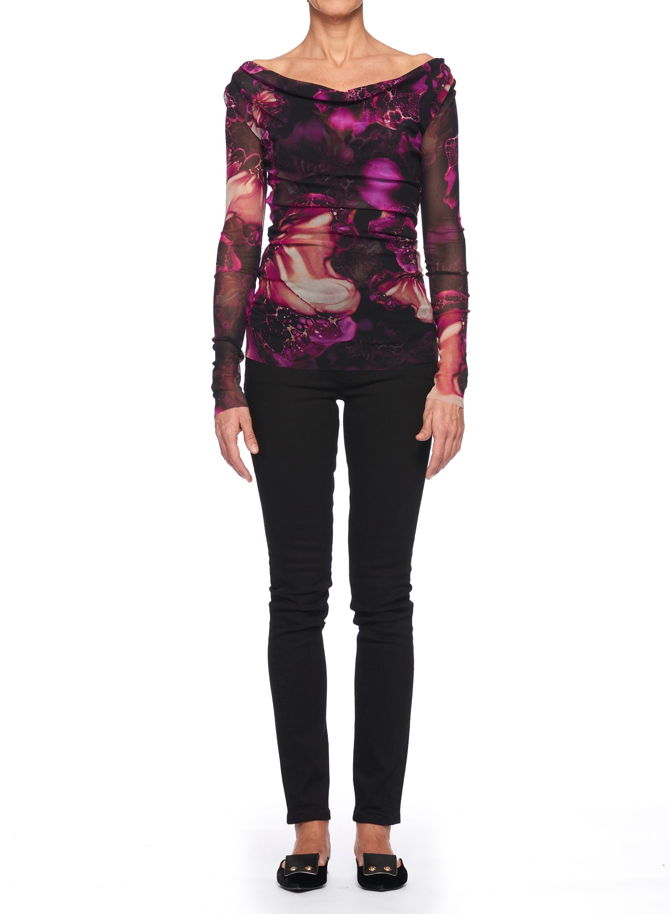 A person wearing the Fuzzi Woman Mesh Top with Nature Pattern, featuring a long-sleeved design with shades of purple and black that exude vintage charm. They pair it with sleek black pants and shoes, set against a plain white background.