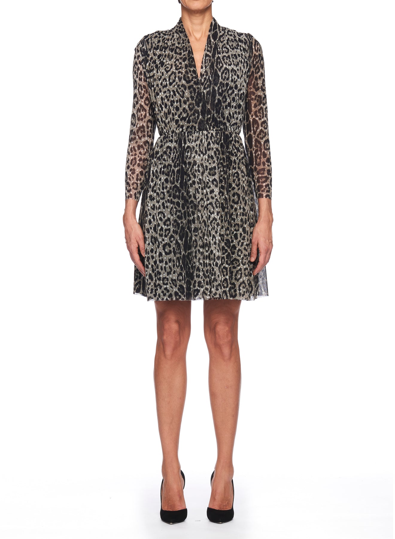 A person wearing the Fuzzi Woman Leopard Print Mesh Dress by Fuzzi pairs it with black high heels. This statement piece showcases a cinched waist, V-neckline, and an asymmetrical hemline, all set against a neutral background, complemented by sheer long sleeves.