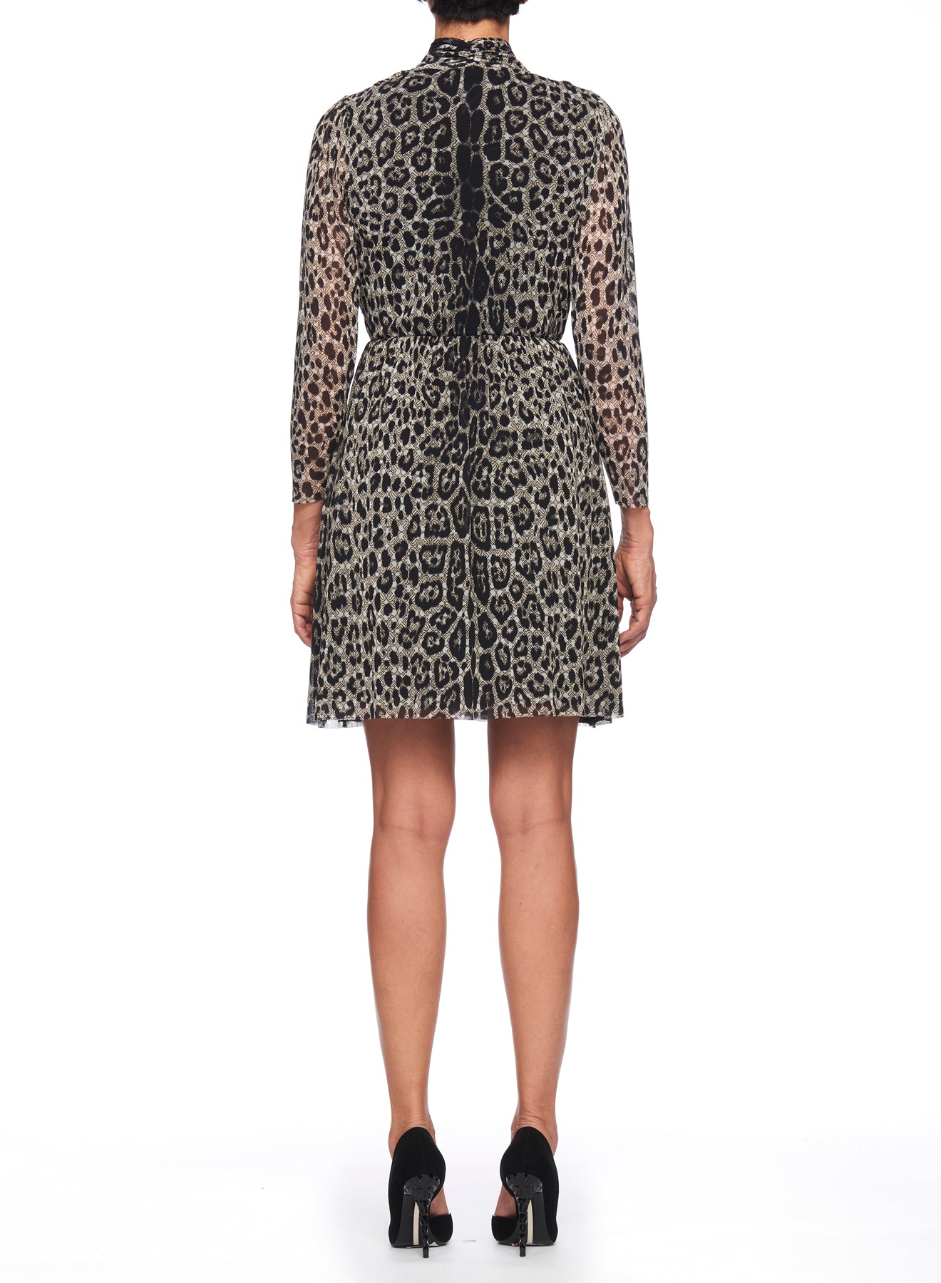 The rear view showcases a person wearing the Fuzzi Woman Leopard Print Mesh Dress, which truly stands out as a statement piece. The dress features long sleeves and a slightly flared, asymmetrical hemline that add an elegant touch. Completing the outfit with black high-heeled shoes against a plain white background enhances the overall look.