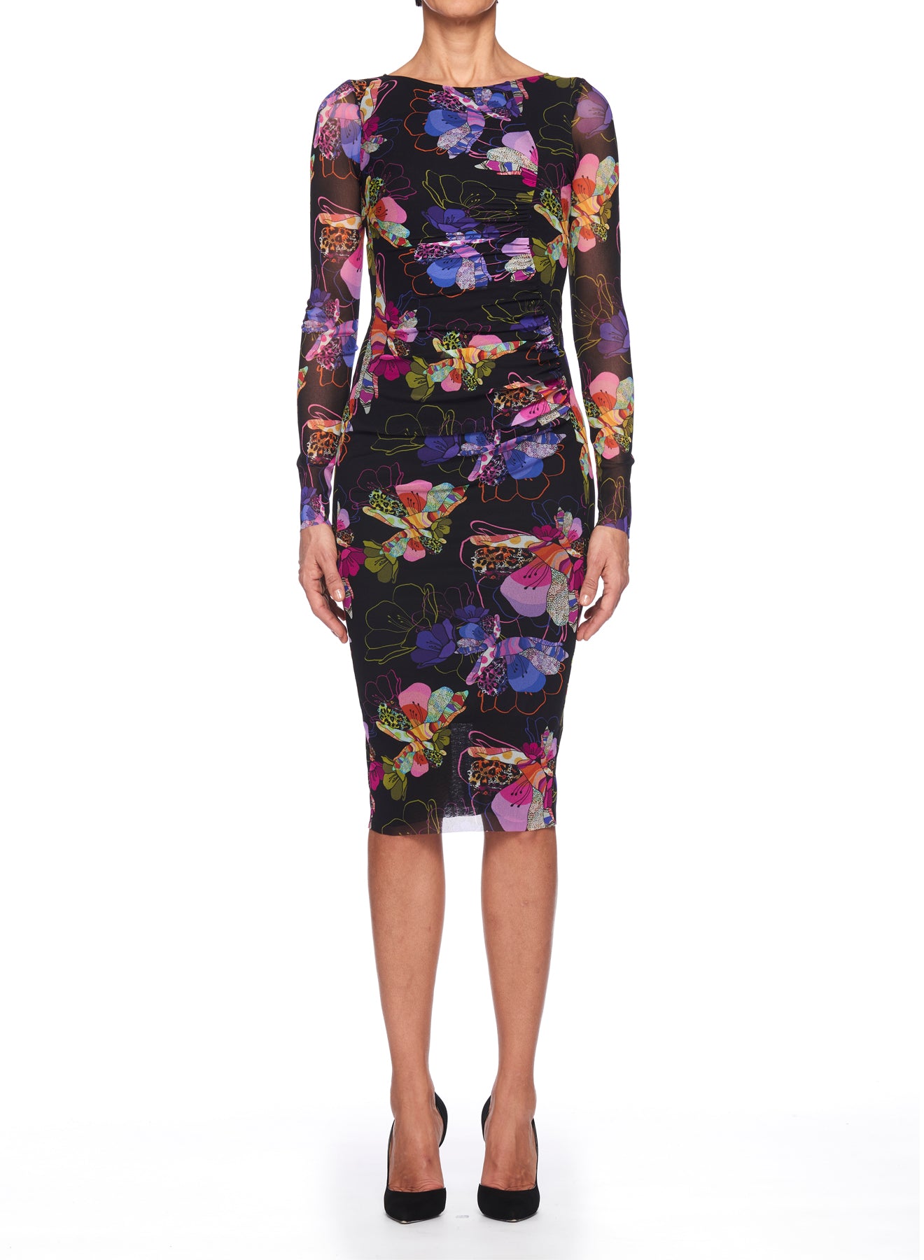 Wearing the Fuzzi Woman Floral Midi Dress by Fuzzi, a person showcases an eye-catching abstract floral pattern on a black background, enhanced by the delicate charm of sheer mesh fabric. The dress's knee-length hemline pairs gracefully with sleek black high heels.