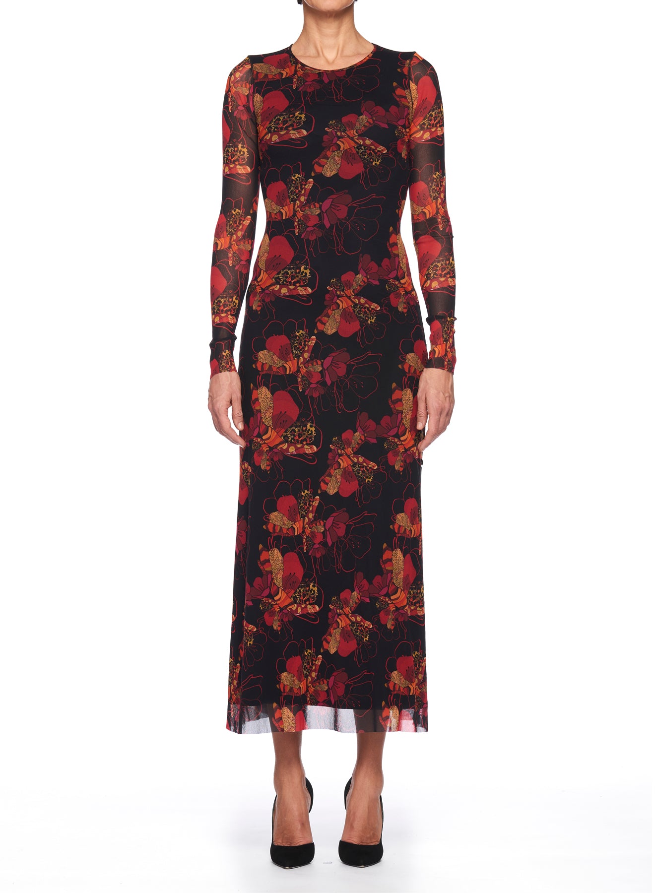 A person is dressed in the Fuzzi Woman Romantic Floral Mesh Dress, featuring long sleeves and an ankle-length black silhouette adorned with a red floral print, standing against a white background. Complemented by black high-heeled shoes, the outfit radiates vintage charm.