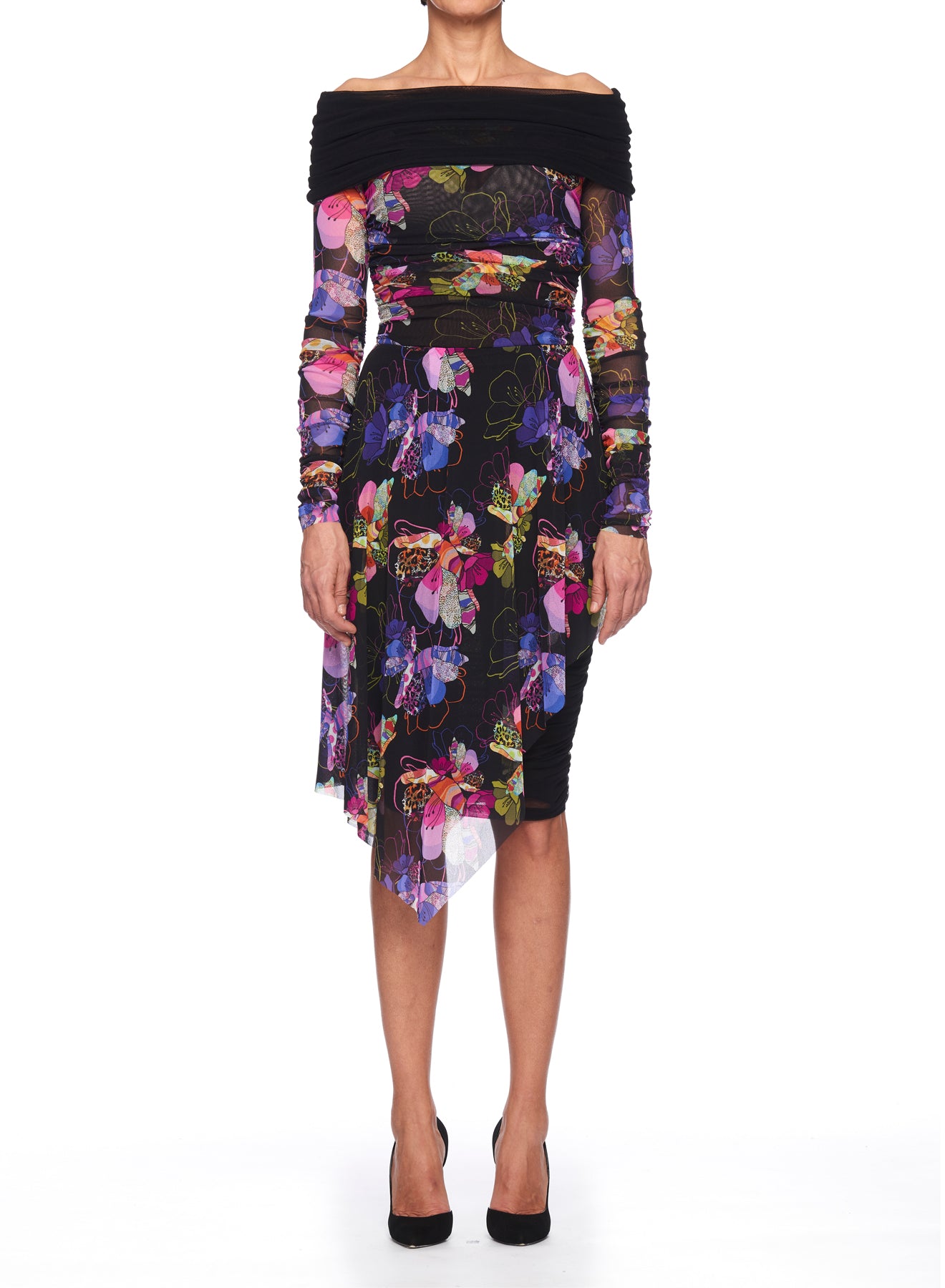 A person wearing the Fuzzi Woman Off-Shoulder Dress by Fuzzi, showcasing a vintage-inspired design with vibrant floral patterns in pink, purple, and green tones. The asymmetrical dress features long sleeves and is perfectly paired with black heels against a plain white background.