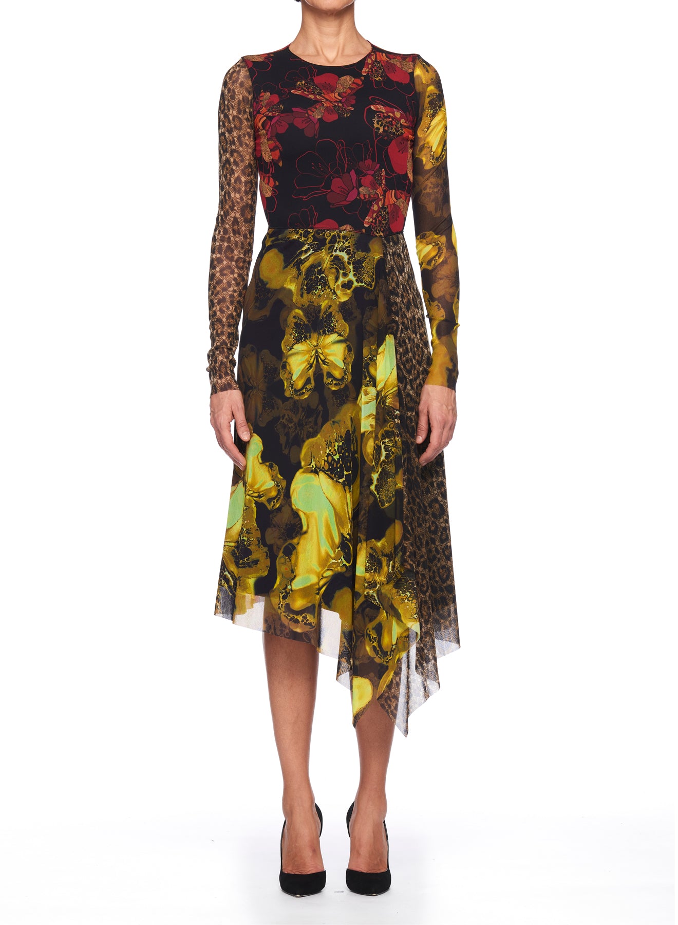 A person wears the striking Fuzzi Woman Mixed-Print Mesh Dress by Fuzzi, featuring an array of animal and floral prints, including yellow flower patterns and red blossoms, accented by leopard-print sleeves. The dress boasts an asymmetrical hemline and pairs elegantly with black high heels.