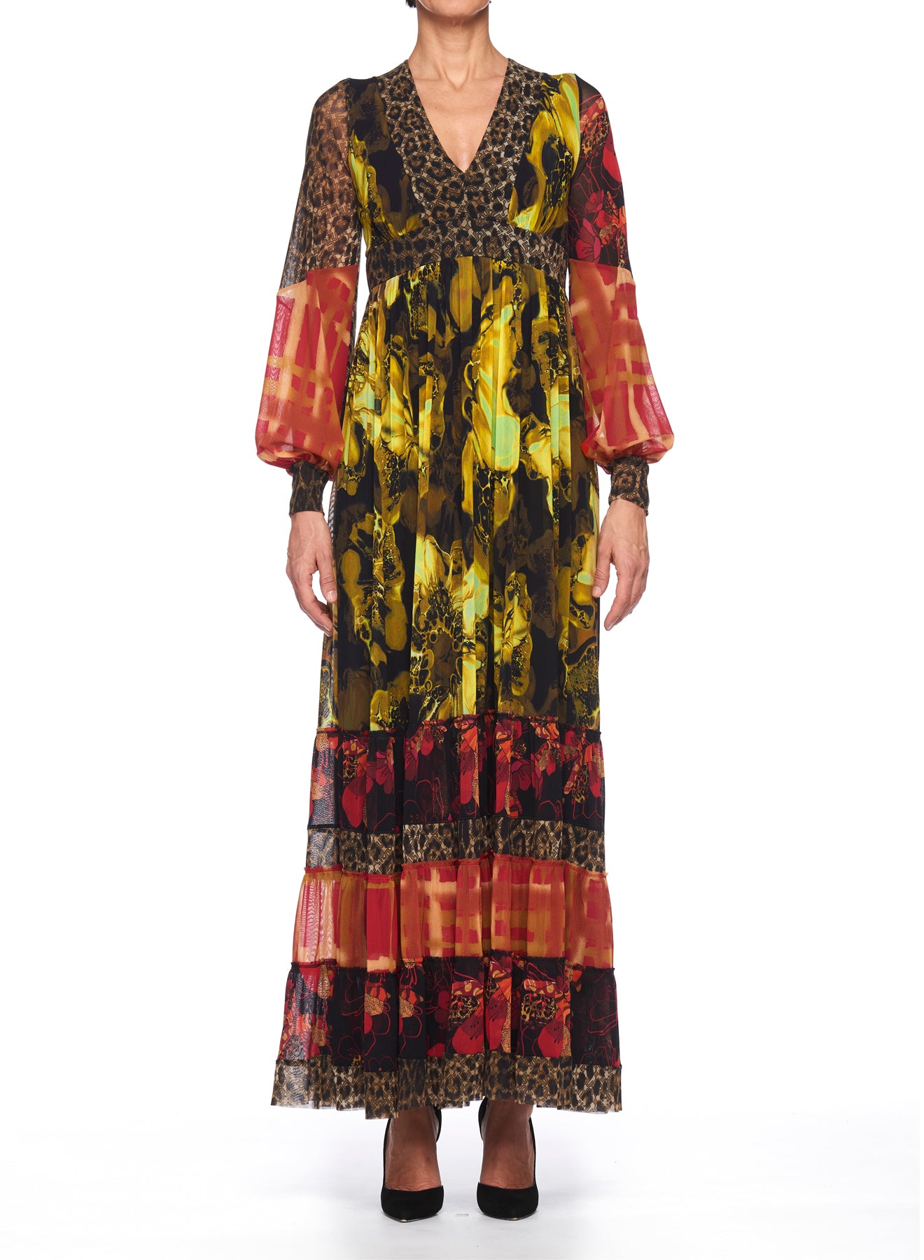 A person wearing the Fuzzi Woman Boho-Chic Mixed-Print Maxi Dress, which combines floral and leopard print designs. The dress showcases a V-neckline and sheer, voluminous sleeves in vibrant red and yellow hues, crafted from mesh fabric. The individual stands against a plain white background.