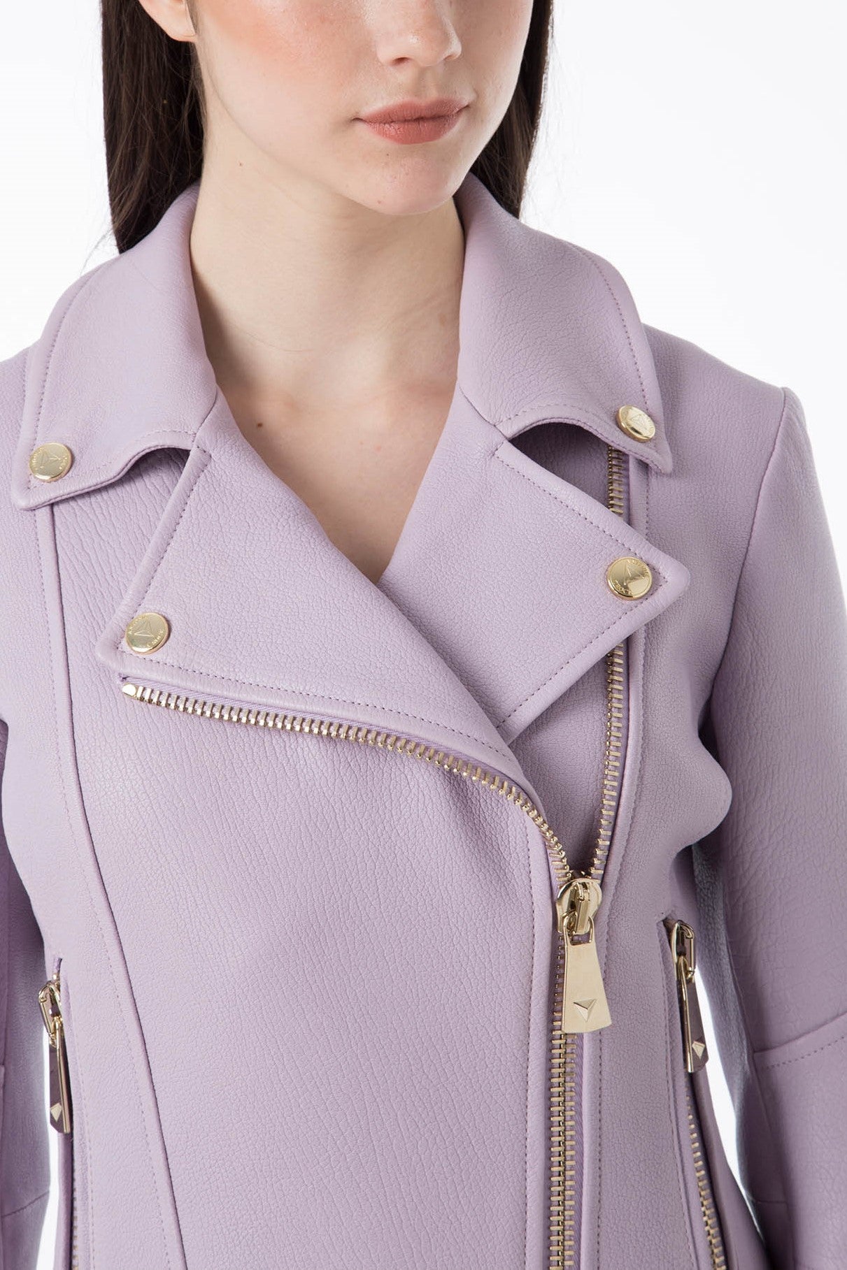 A woman wears the Antonio Croce Ginette Jacket, featuring a soft lavender color and elegant gold hardware. The image is cropped to highlight her shoulders and part of her face, showcasing the intricate details of this vintage piece’s design by Antonio Croce.